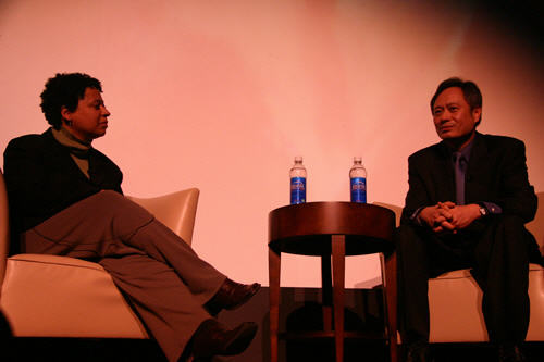 Ang Lee and Lisa Kennedy on the stage of the Ellie Caulkins Opera House