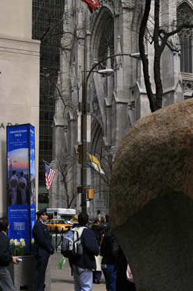 The personality-deficient security guard to the left chewed people out<br>for standing on the piece of art's platform.