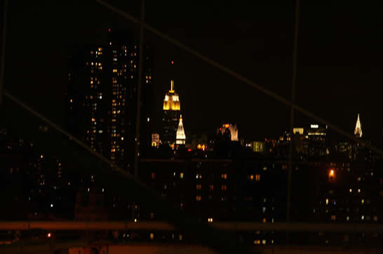 ... the Brooklyn Bridge by night.